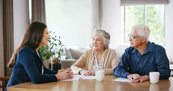Shot of a senior couple meeting with a consultant to discuss paperwork at home